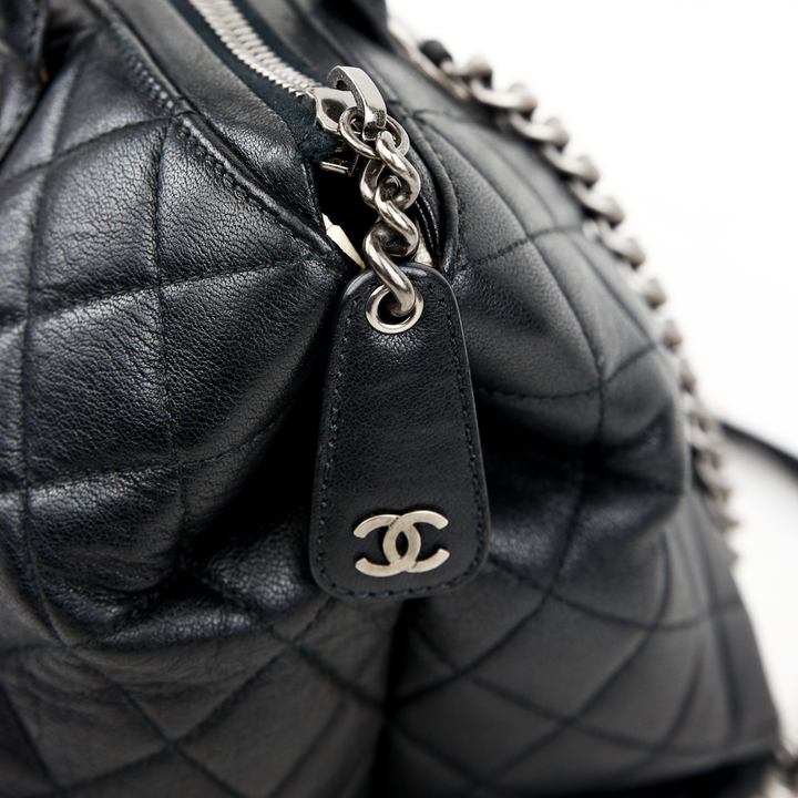 zipper pull view of Chanel Boy Chained Medium Black Quilted Tote Bag