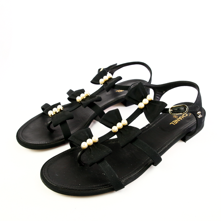 Side view of Chanel Black Fabric 
Pearl Bow Sandals