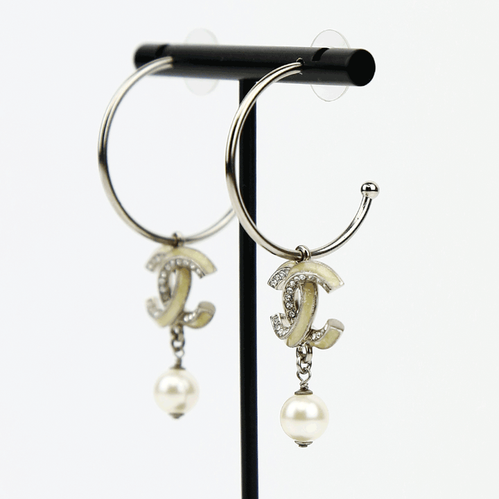 side view of Chanel Silver 
Enamel CC Hoop Earrings