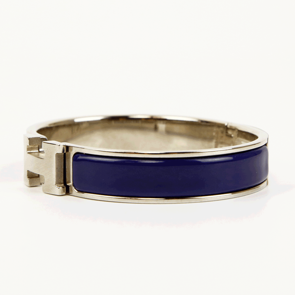 side view of Hermès Navy 
Silver Clic H Bangle