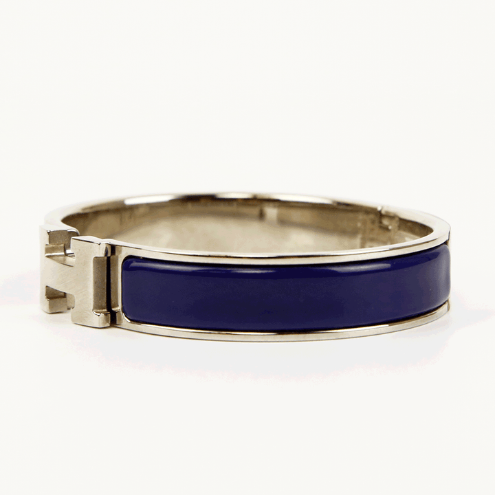 side view of Hermès Navy 
Silver Clic H Bangle