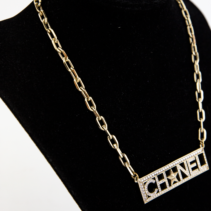 Side view of Chanel Gold 
Crystal Nameplate Necklace